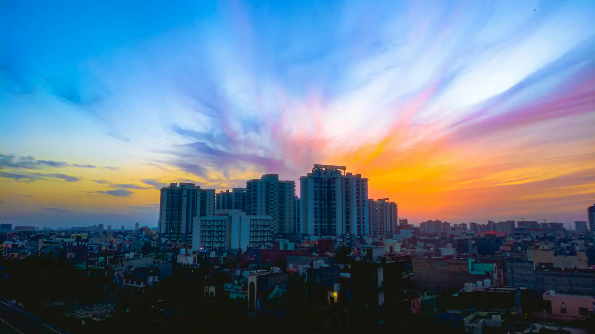 Gurugram skyline at sunset with high-rise towers